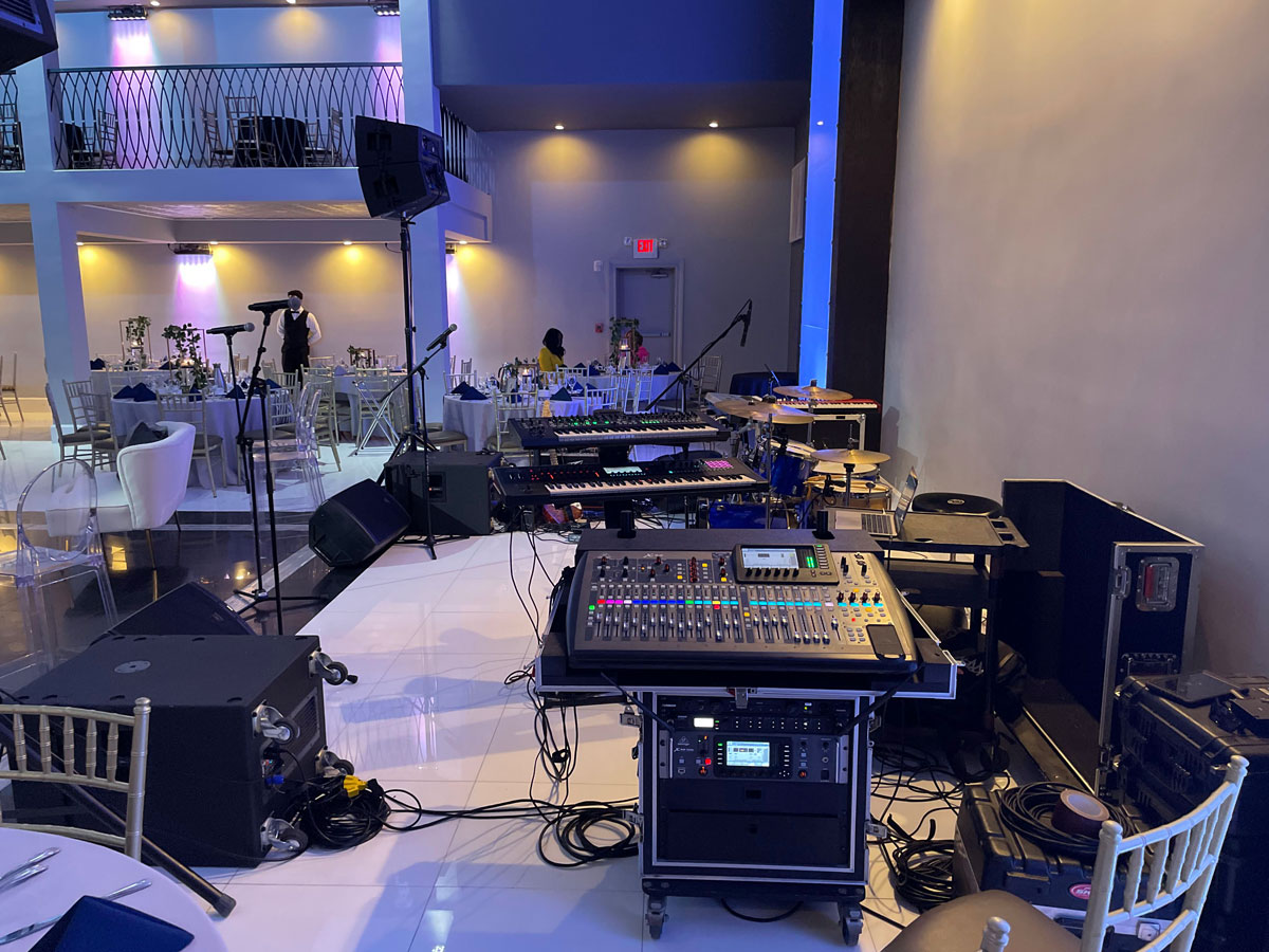 Full banquet hall sound system setup with digital mixing console and stage monitors for live band event New Jersey